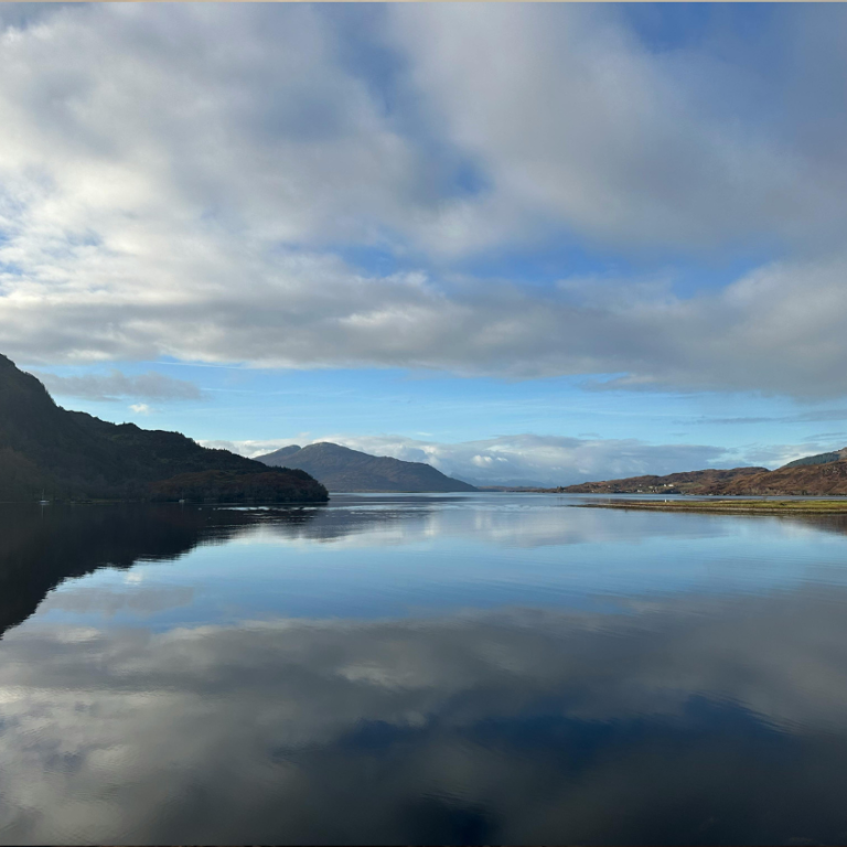 Calm Scottish loch surrounded by hills during a Shore to Crannog open water swimming course in Stirlingshire